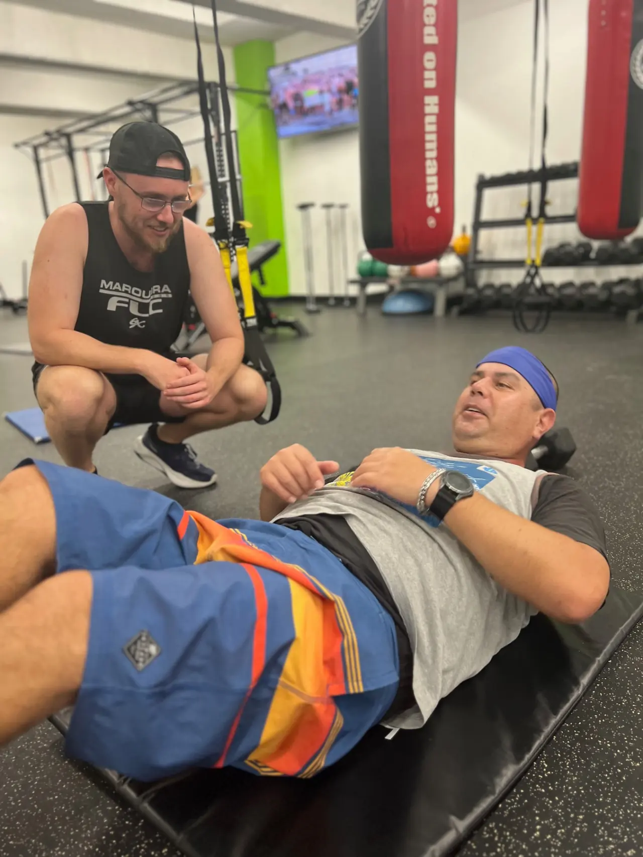 6X Training coach coaching an NDIS member through a floor exercise at the Maroubra studio